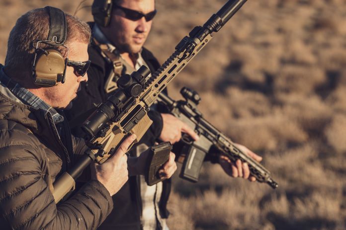 Two AR-15 rifles chambered in 5.56 NATO being used out in the desert