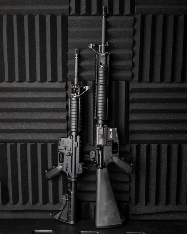Two AR-15 Rifles set next to each other on a black background