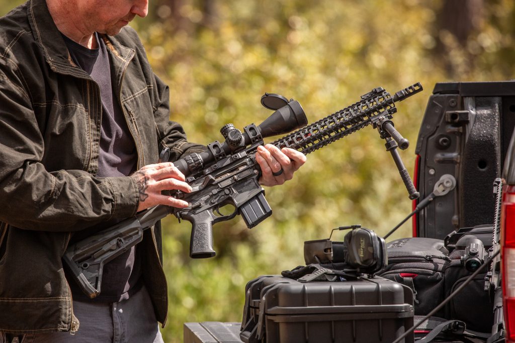 AR-15 Upper Receiver with scope attached and being held