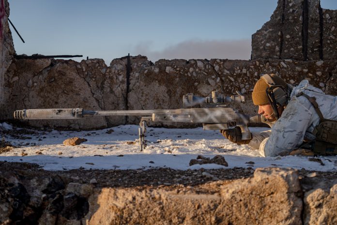 bolt action rifle in a snowy environment