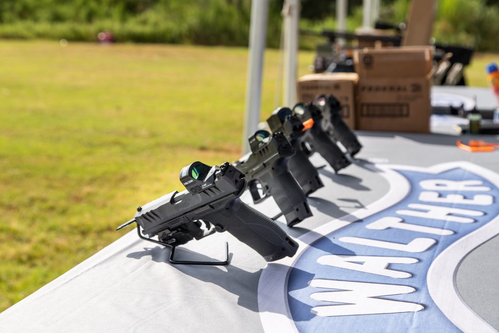 row of 3 gun pistols on a table