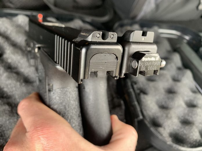A glock handgun next to a glock handgun with a switch that allows it to fire full auto