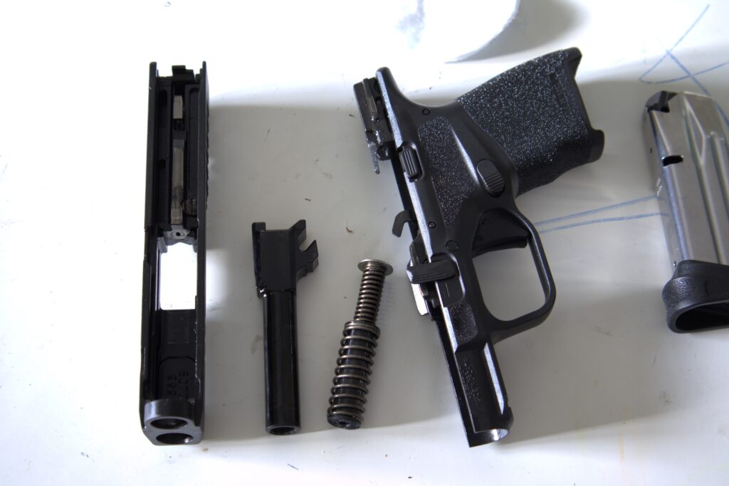 springfield hellcat osp disassembled on a white table