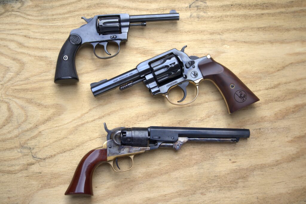 henry golden boy revolver between a colt new police at the top and a colt pocket navy revolver at the bottom