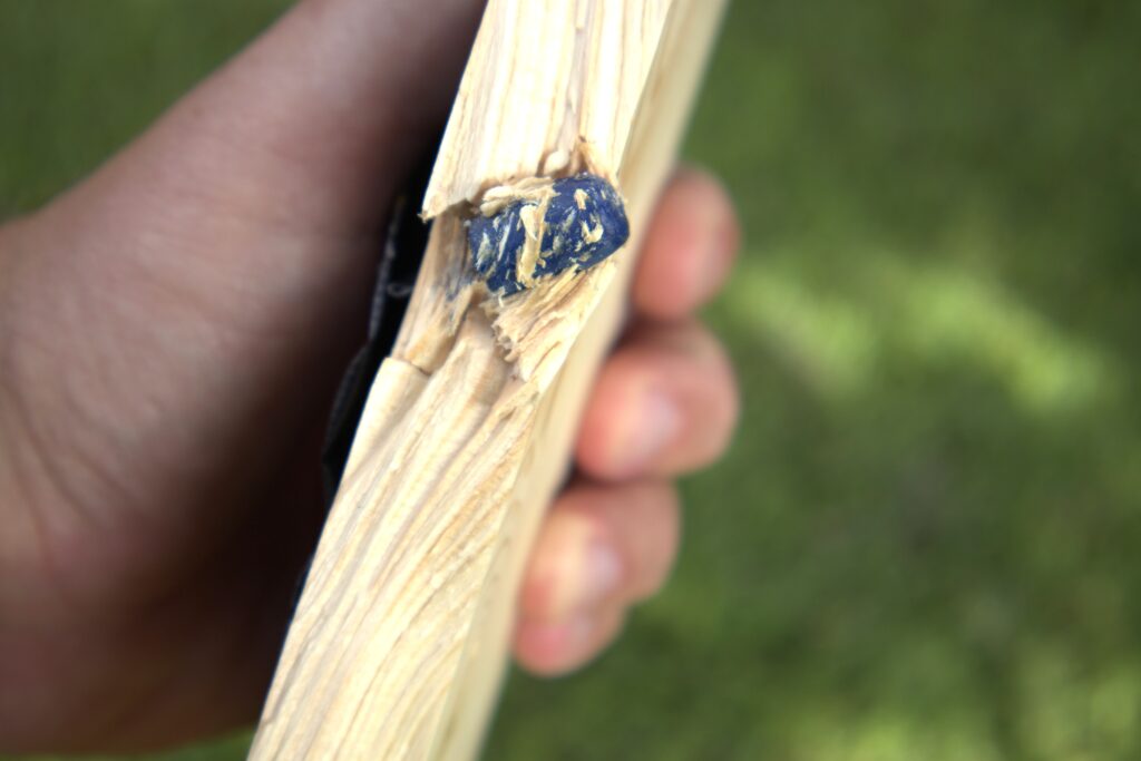 federal syntech 10mm bullet stuck in a pine board